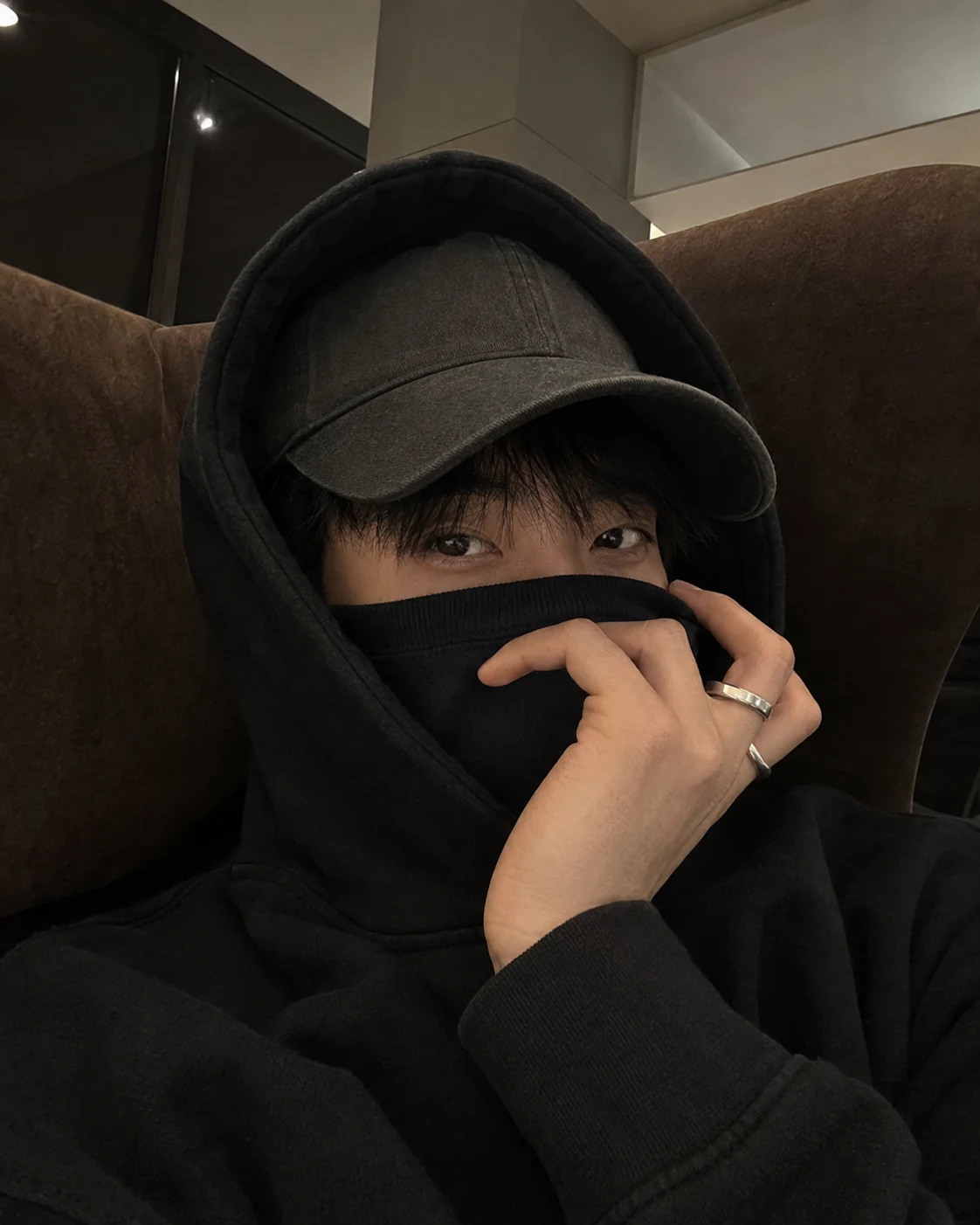 Lee Joon-Seok in a black cap and hoodie during a quiet off-duty moment.